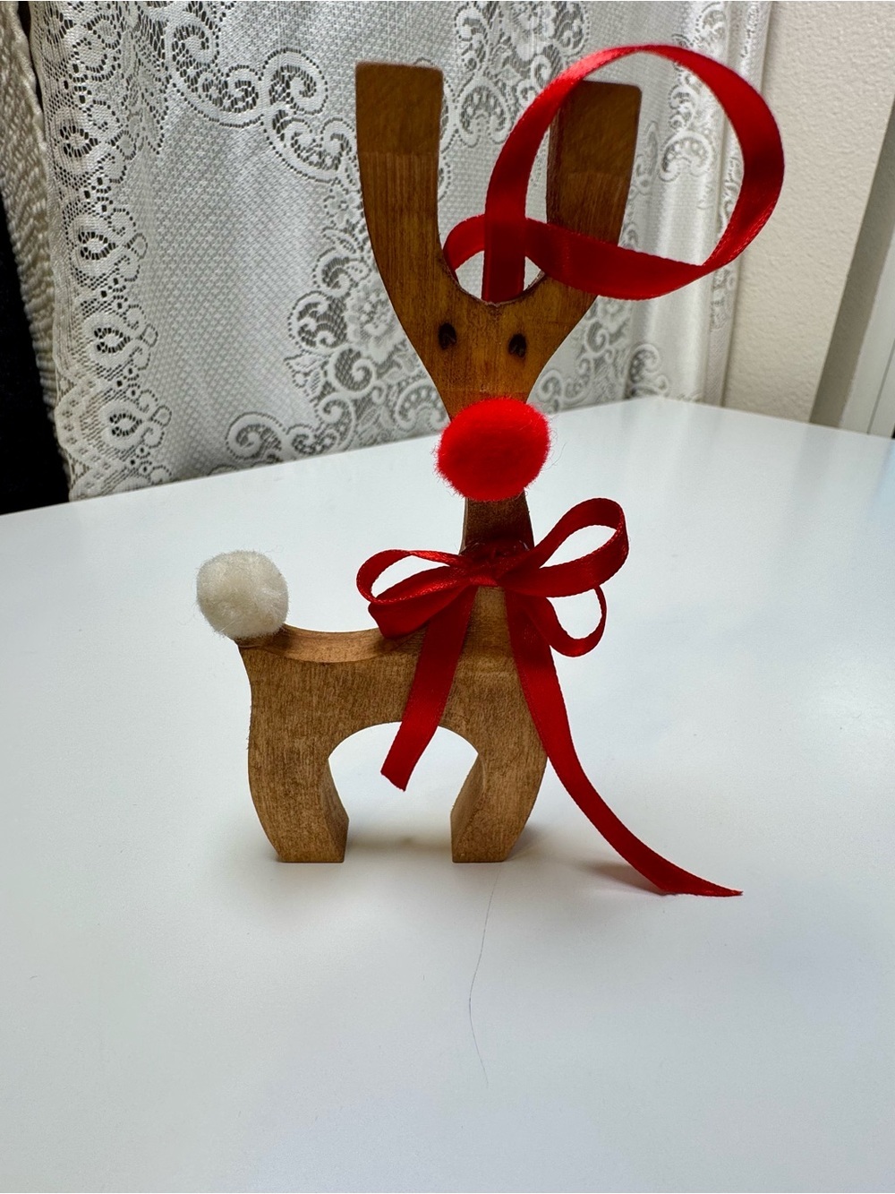 Homemade Wooden Reindeer Holiday Décor with Red Ribbon and Pom-Poms